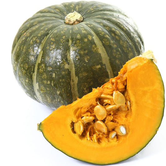Whole and sliced green pumpkin on a white background